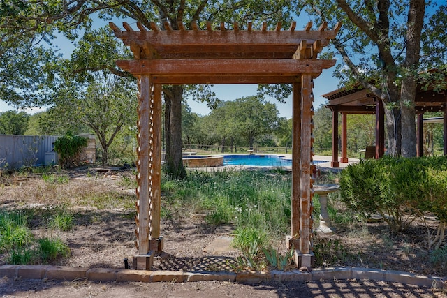 view of yard featuring a pergola and a fenced in pool