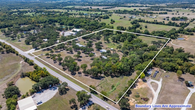 birds eye view of property featuring a water view and a rural view