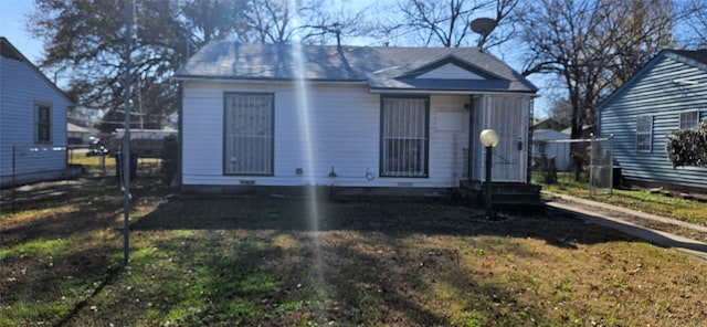 bungalow-style house with fence