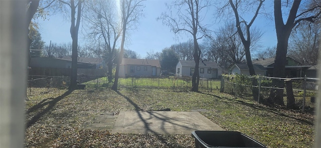 view of yard with a residential view and fence