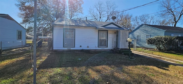 bungalow-style house with a front lawn