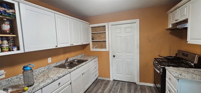 kitchen with dark hardwood / wood-style flooring, light stone counters, gas range, sink, and white cabinetry