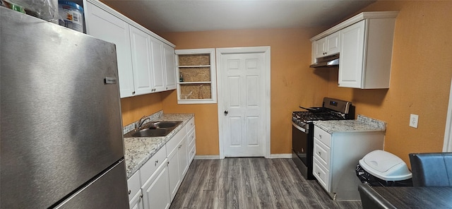 kitchen with dark hardwood / wood-style floors, sink, white cabinetry, and stainless steel appliances