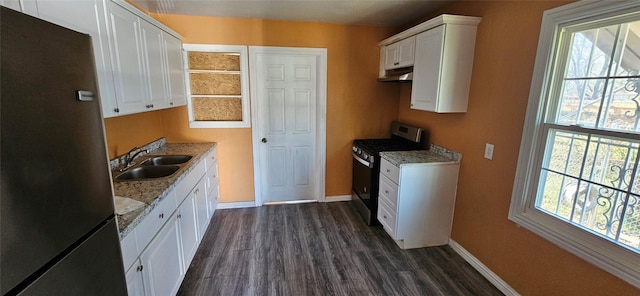 kitchen featuring white cabinets, sink, dark hardwood / wood-style flooring, light stone counters, and stainless steel appliances