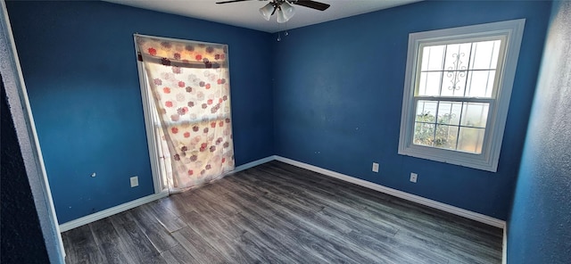 empty room with baseboards, wood finished floors, and ceiling fan