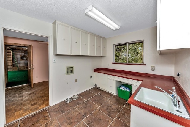 laundry room featuring sink, cabinets, washer hookup, electric dryer hookup, and a textured ceiling