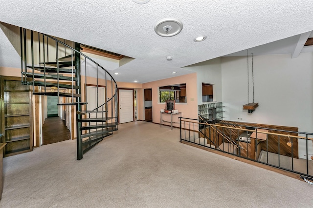 interior space featuring carpet flooring and a textured ceiling