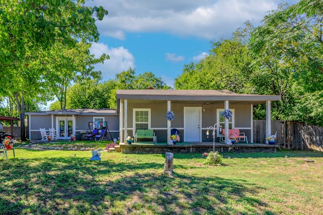 view of front of property with french doors, a front lawn, and ceiling fan