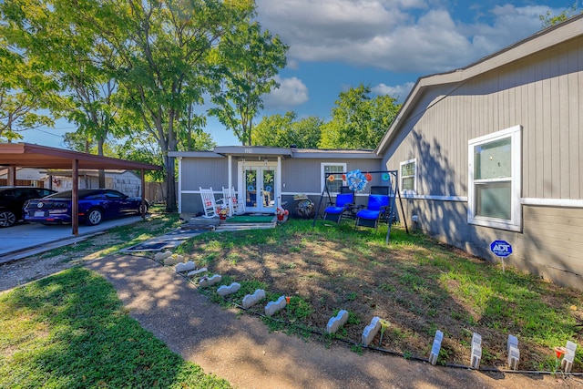 exterior space with a carport and french doors