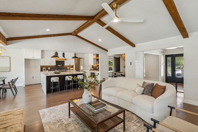 living room with ceiling fan, hardwood / wood-style flooring, and lofted ceiling with beams