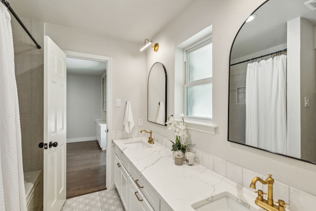 bathroom featuring wood-type flooring, vanity, and shower / tub combo with curtain