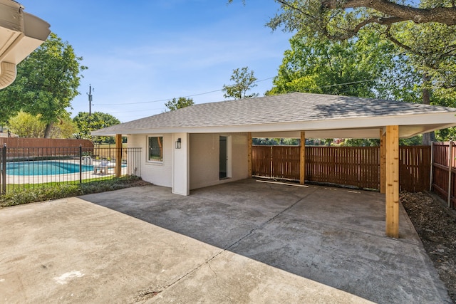 view of parking / parking lot with a fenced in pool and a gazebo