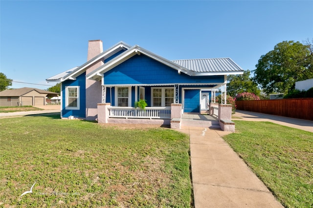 view of front of house with a front lawn and covered porch