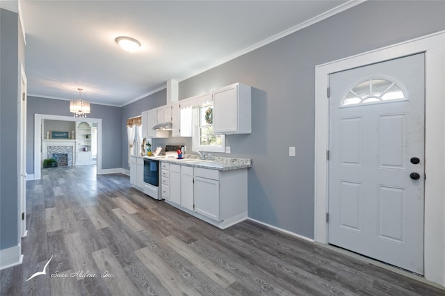 kitchen with white cabinets, wood-type flooring, crown molding, white range with electric stovetop, and a notable chandelier