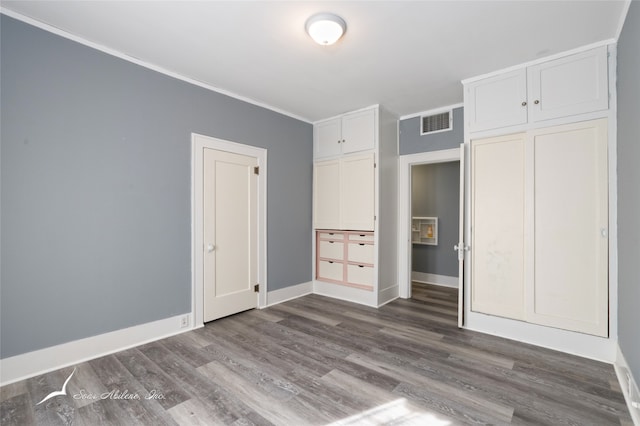 unfurnished bedroom featuring a closet and dark hardwood / wood-style floors