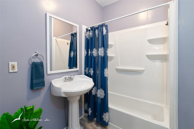 bathroom with shower / tub combo with curtain and hardwood / wood-style flooring