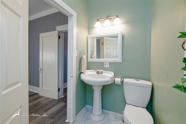 bathroom with marble finish floor, baseboards, and toilet