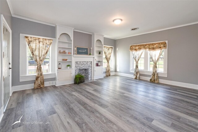 unfurnished living room featuring visible vents, crown molding, baseboards, a fireplace, and wood finished floors