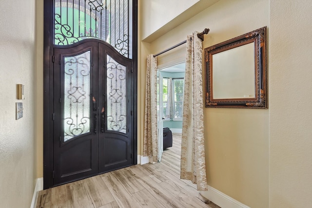 entrance foyer featuring french doors and light wood-type flooring