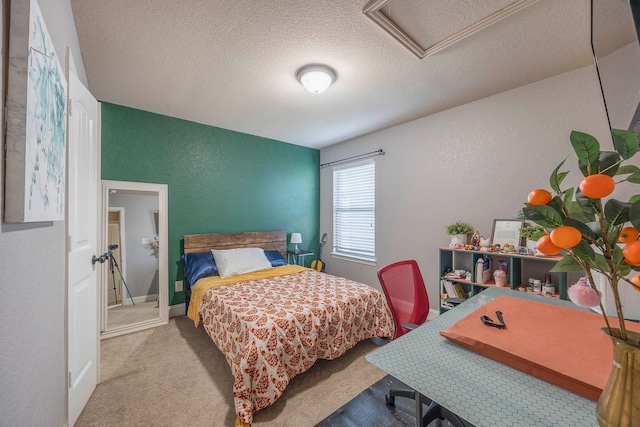 bedroom with a textured ceiling and light carpet