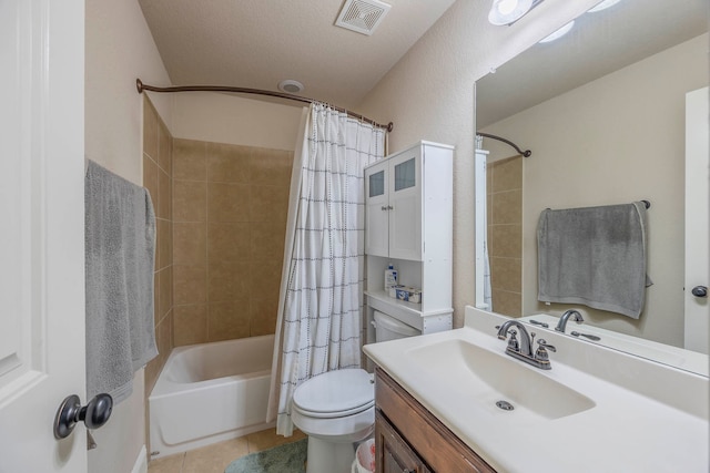 full bathroom featuring shower / bathtub combination with curtain, vanity, a textured ceiling, toilet, and tile patterned floors