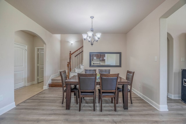 dining area featuring light hardwood / wood-style floors and a chandelier