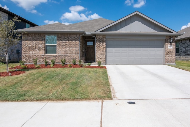 view of front of home with a front lawn and a garage