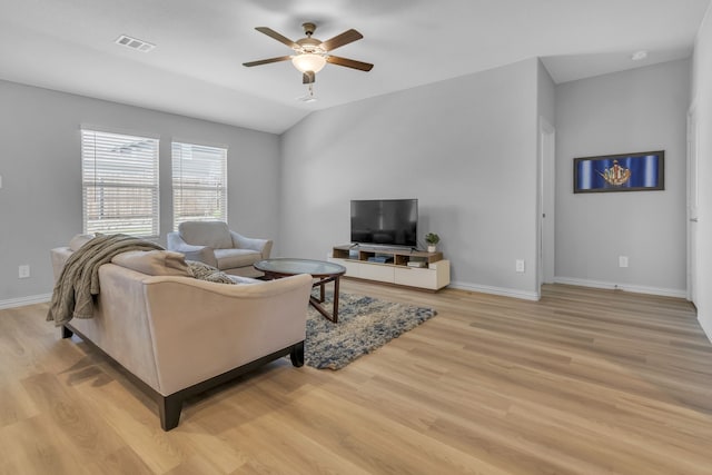 living room featuring ceiling fan, light hardwood / wood-style flooring, and vaulted ceiling