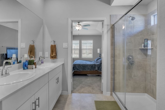 bathroom featuring tile patterned floors, ceiling fan, a shower with door, and vanity