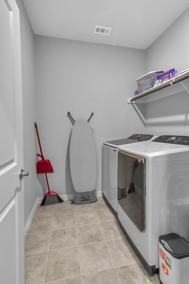 laundry room with light tile patterned floors and washer and dryer