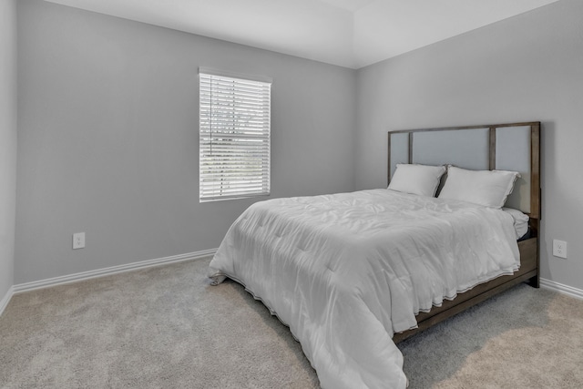 bedroom featuring light carpet