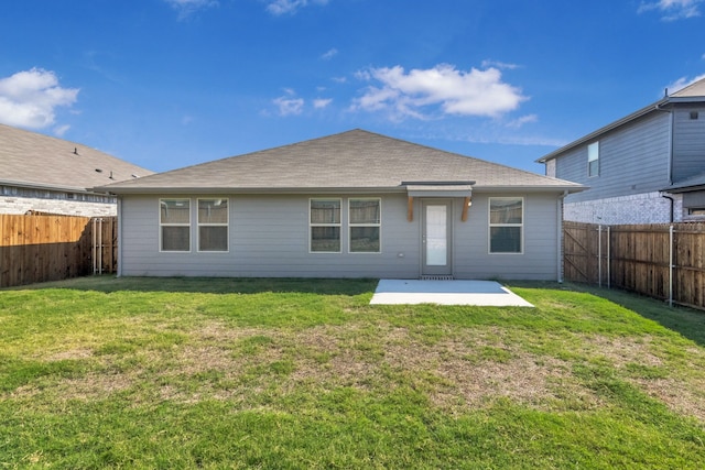 rear view of house with a lawn and a patio area