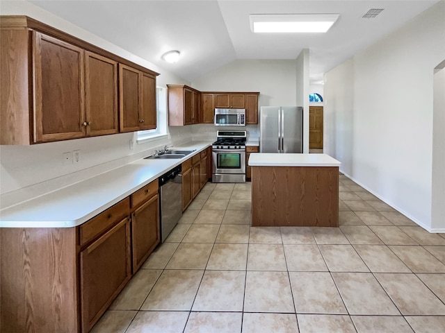 kitchen with light tile patterned floors, stainless steel appliances, lofted ceiling, a center island, and sink