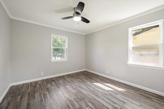 spare room with a healthy amount of sunlight, ornamental molding, dark wood-type flooring, and ceiling fan