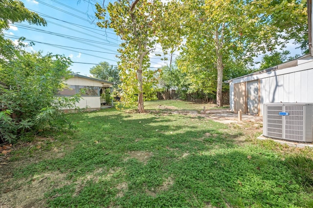 view of yard featuring cooling unit and an outdoor structure