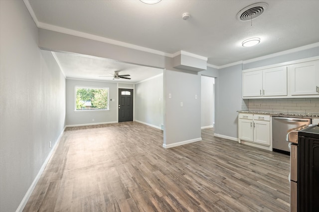 kitchen with tasteful backsplash, white cabinets, stainless steel appliances, ceiling fan, and hardwood / wood-style flooring