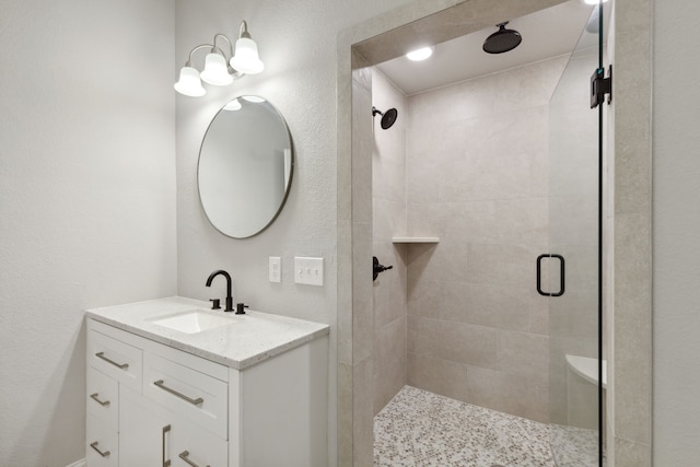 bathroom featuring vanity and an enclosed shower