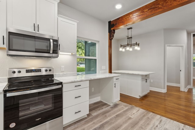 kitchen with appliances with stainless steel finishes, light wood-type flooring, light stone counters, white cabinetry, and hanging light fixtures