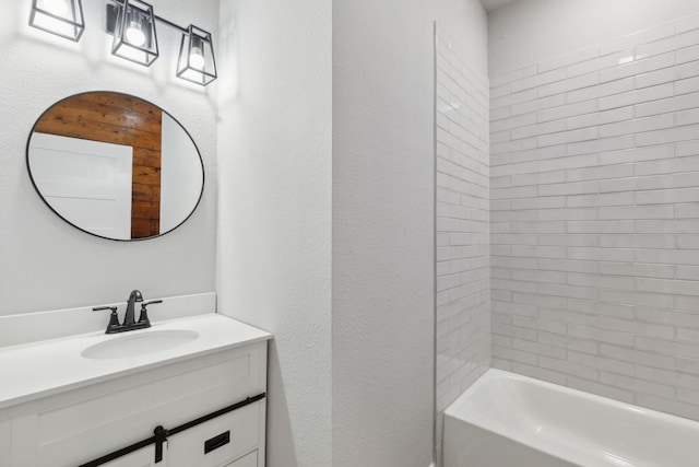 bathroom with vanity and tiled shower / bath combo