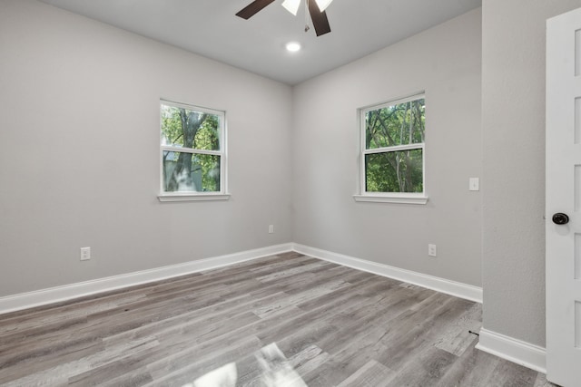 spare room with light hardwood / wood-style floors, plenty of natural light, and ceiling fan