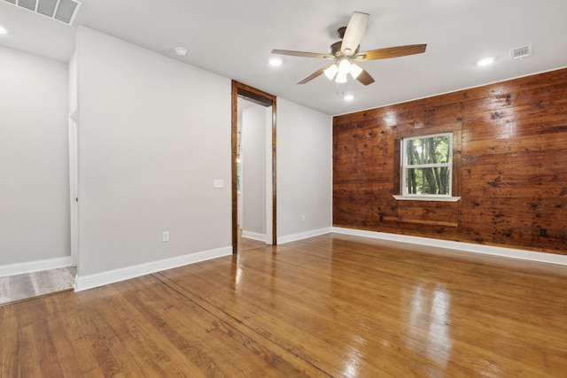 empty room with wood-type flooring and ceiling fan