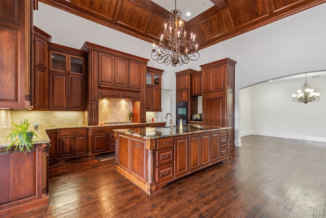 kitchen with a notable chandelier, an island with sink, decorative light fixtures, dark hardwood / wood-style flooring, and wooden ceiling