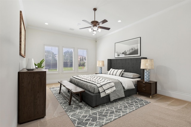 bedroom featuring crown molding, ceiling fan, and light colored carpet