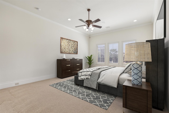 bedroom with ceiling fan, light carpet, and ornamental molding