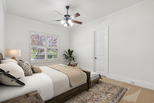 bedroom featuring ceiling fan, crown molding, and carpet flooring