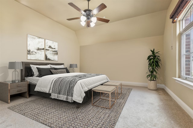 bedroom featuring multiple windows, carpet, vaulted ceiling, and ceiling fan