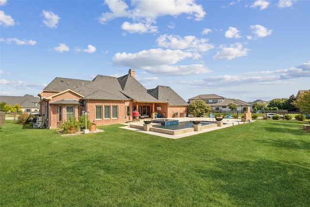 back of house with a yard and a patio area