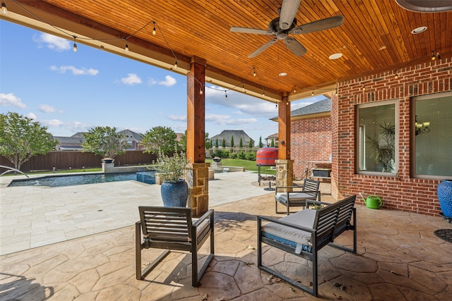 view of patio with a fenced in pool and ceiling fan