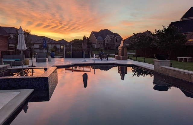 pool at dusk with a patio