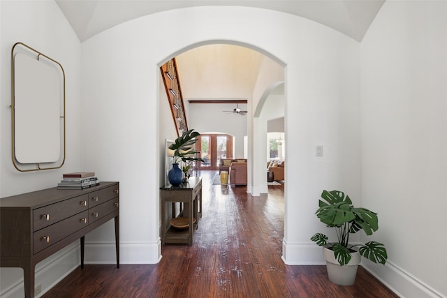 corridor featuring vaulted ceiling and dark hardwood / wood-style flooring